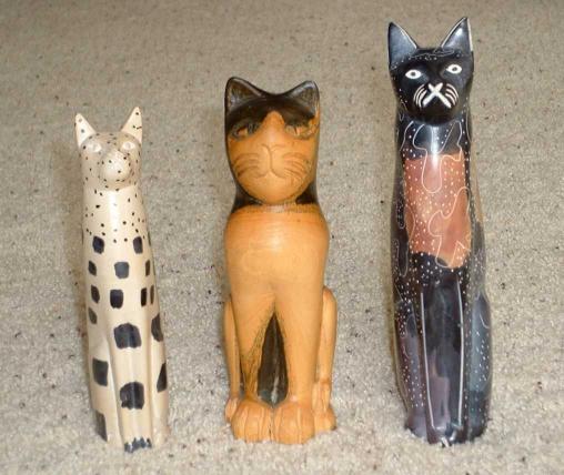Three carved cat statues.