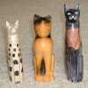 Three carved wood cat statues