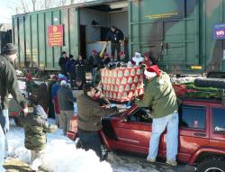 Loading Christmas presents onto Toys for Tots train