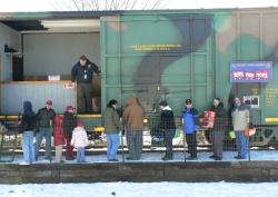 Loading toys onto Toys for Tots train