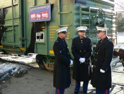 Marines next to Toys for Tots boxcar
