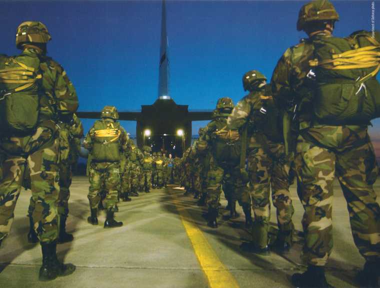 Paratroopers from the 82nd Airborne board a C-130 Hercules at Pope Air Force Base, NC.